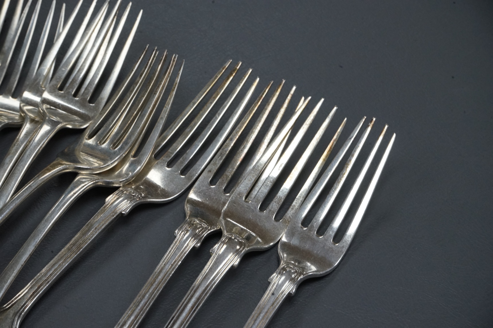 A set of eight George IV provincial silver Hanoverian pattern dessert forks by John Brown, Newcastle, 1822, 16.6cm, together with a set of six early 19th century silver fiddle and thread pattern dessert forks, William Ch